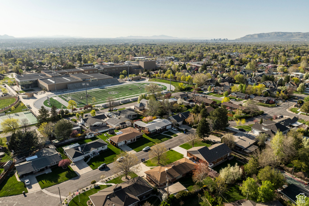 Aerial view of property's location featuring nearby suburban area and a mountainous background