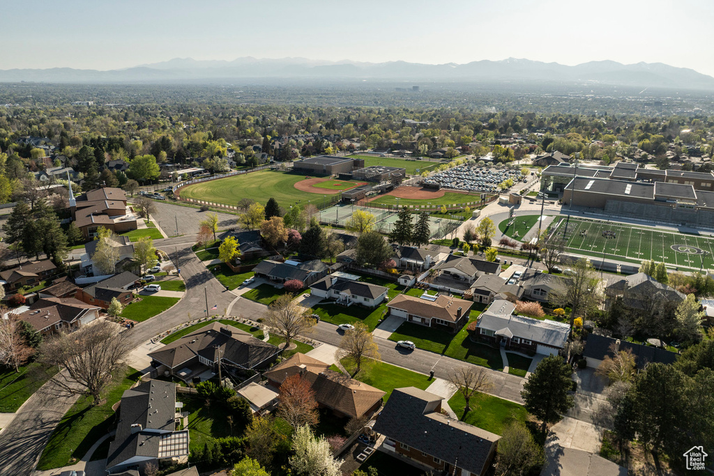 Aerial view of property's location featuring a mountainous background and nearby suburban area