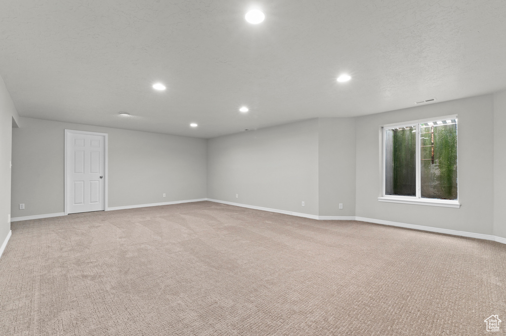 Unfurnished room with baseboards, light carpet, visible vents, and recessed lighting