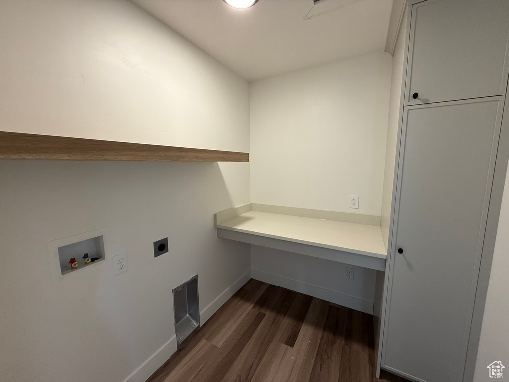 Washroom with washer hookup, electric dryer hookup, dark wood-style flooring, and baseboards
