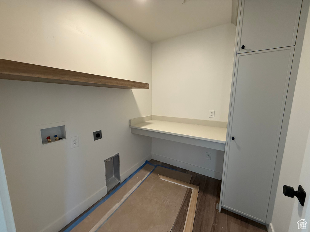Clothes washing area featuring electric dryer hookup, hookup for a washing machine, baseboards, and dark wood-style floors