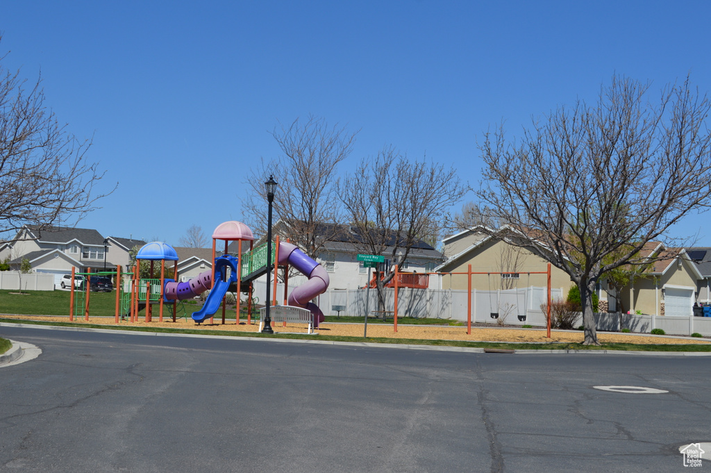 View of street featuring street lights, curbs, and a residential view