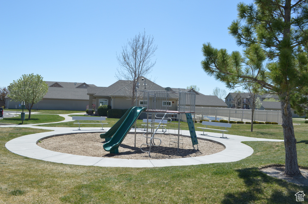 Community play area with a yard and fence