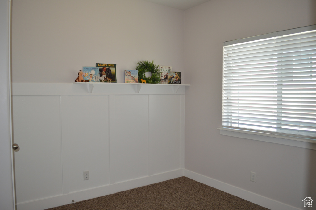 Unfurnished room with carpet flooring and baseboards