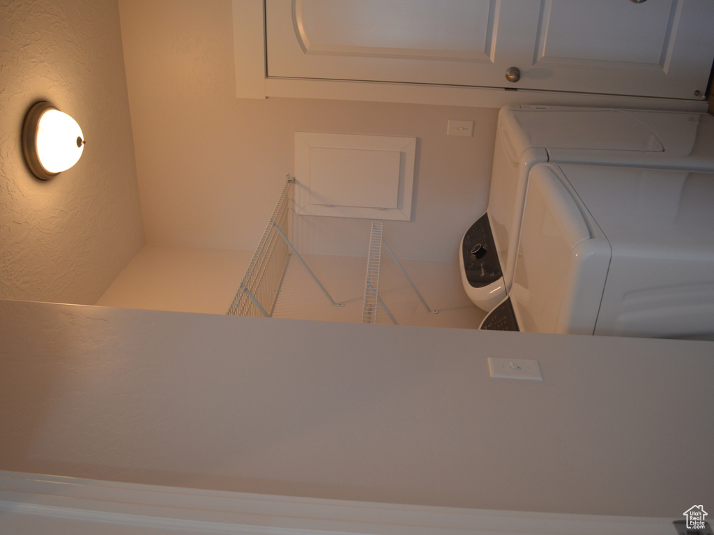 Laundry area featuring laundry area, washing machine and dryer, and a textured ceiling