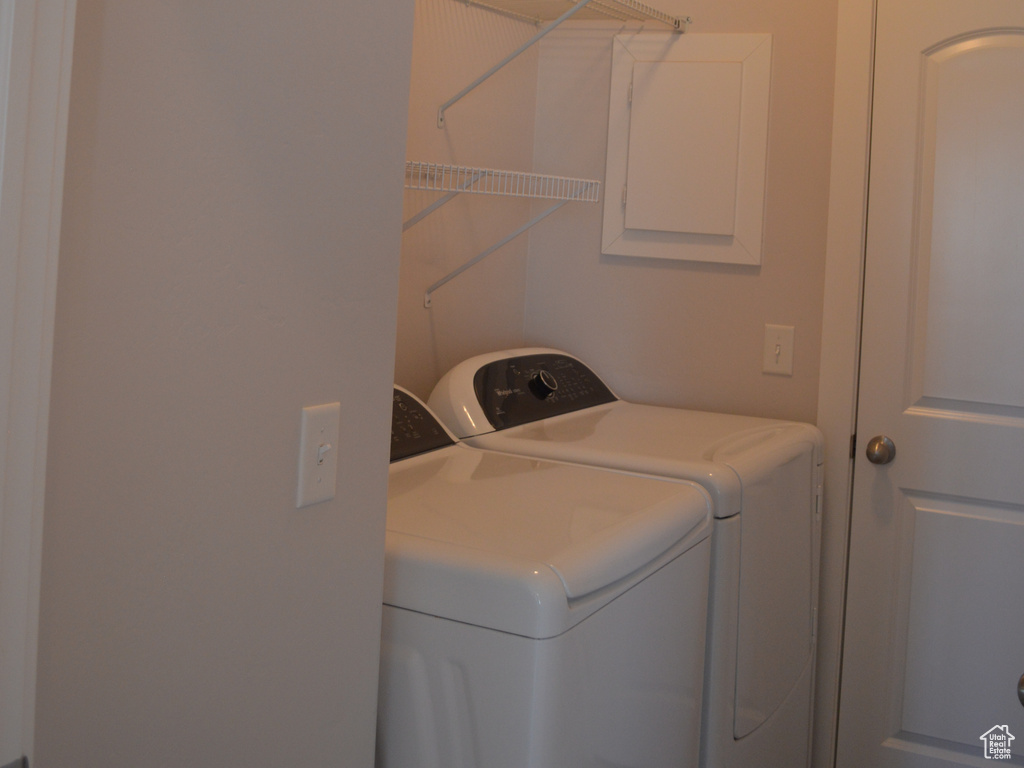 Laundry area featuring laundry area, washing machine and dryer, and a textured ceiling