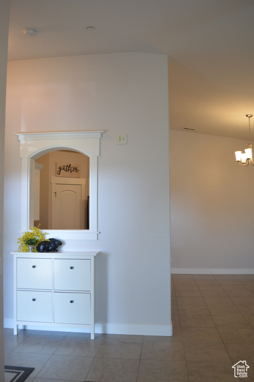 Interior details featuring a chandelier and baseboards