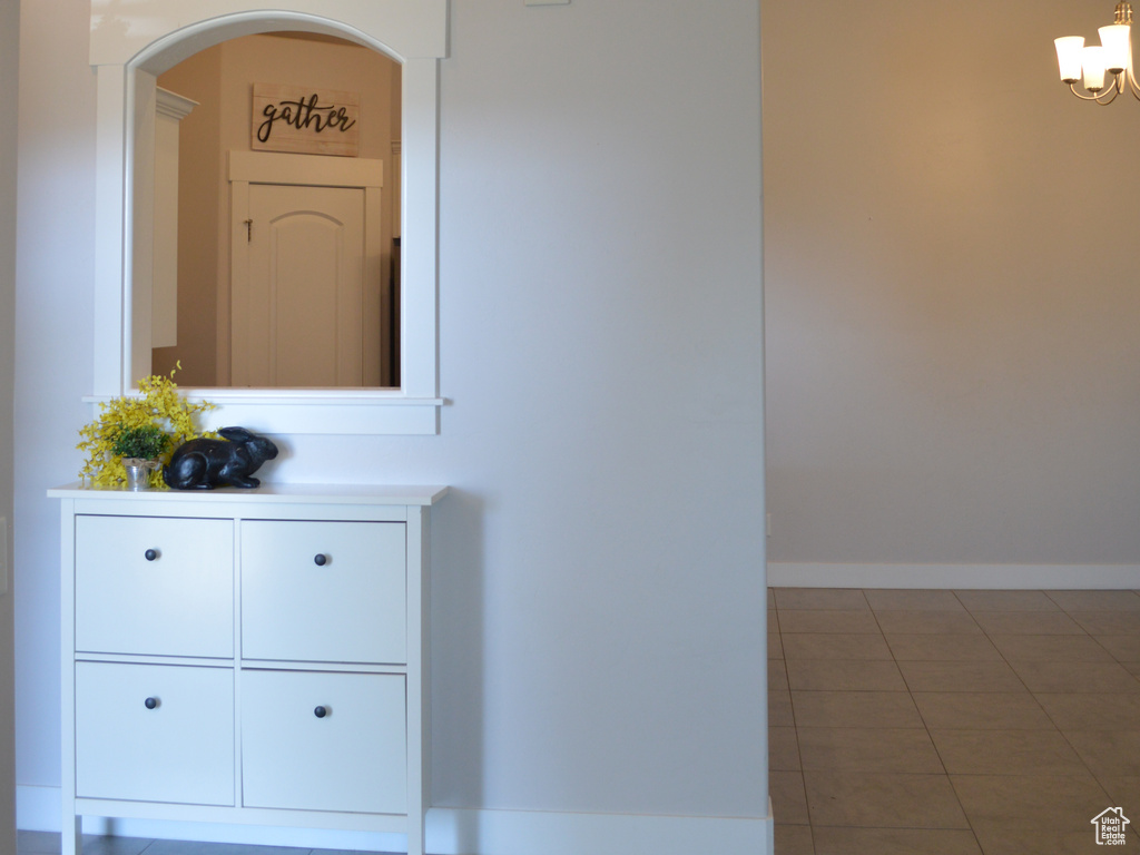 Interior details featuring a chandelier and baseboards