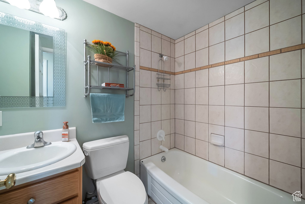Bathroom featuring vanity, washtub / shower combination, and toilet