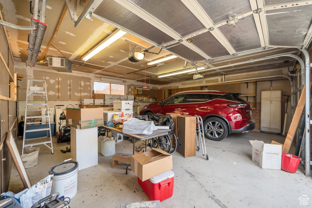 Garage with visible vents and a garage door opener