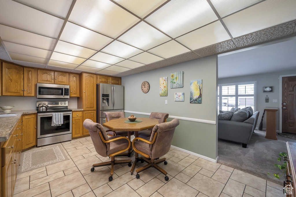 Dining space featuring baseboards and light tile patterned floors