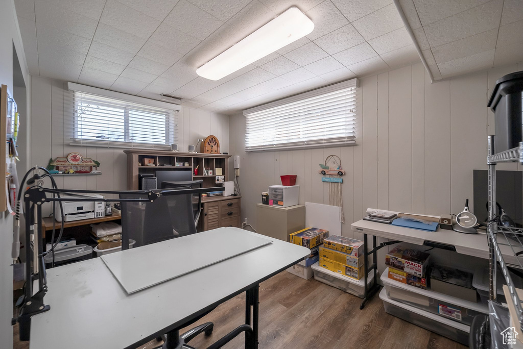 Office space with wood finished floors and plenty of natural light