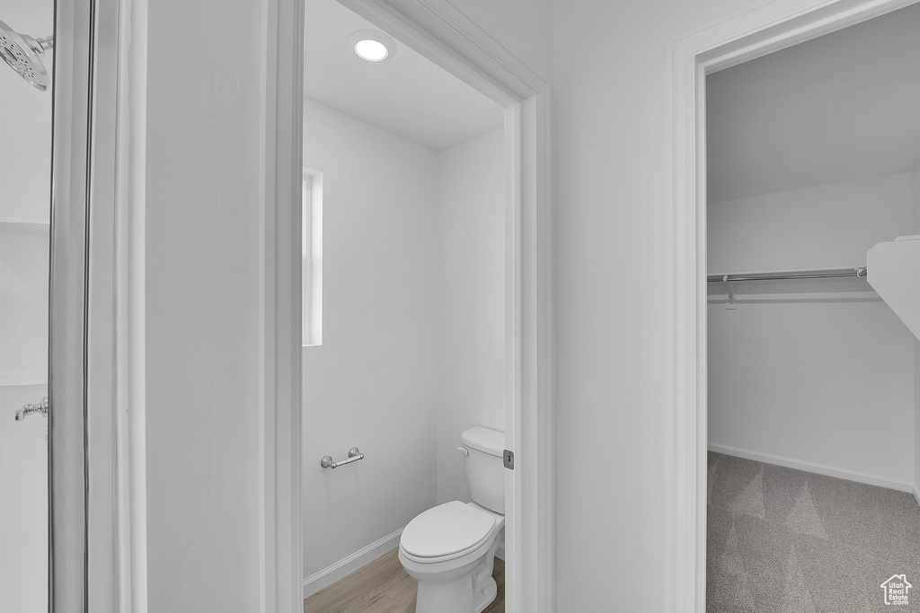 Bathroom with toilet and baseboards
