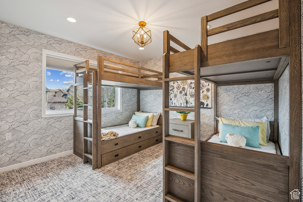Bedroom with wallpapered walls, a chandelier, baseboards, carpet flooring, and recessed lighting