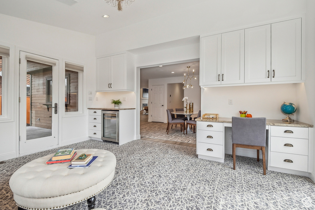 Interior space featuring white cabinets, recessed lighting, and wine cooler
