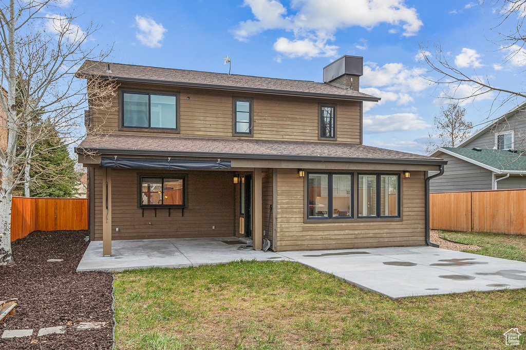Rear view of property with a patio area, a chimney, and a fenced backyard