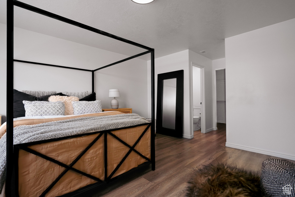 Bedroom with wood finished floors and baseboards