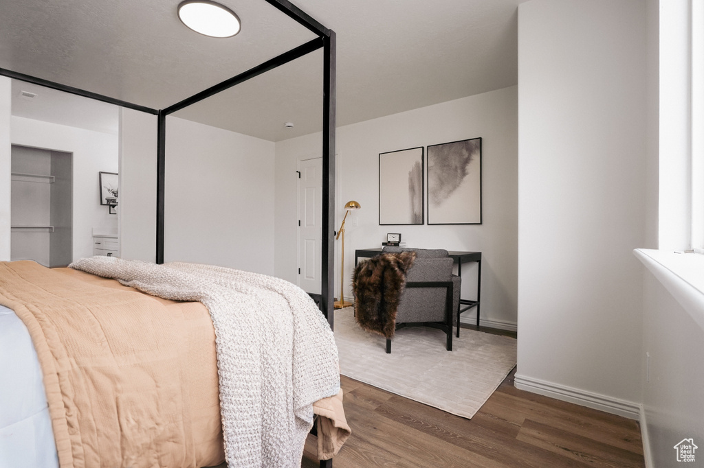 Bedroom featuring dark wood finished floors and baseboards