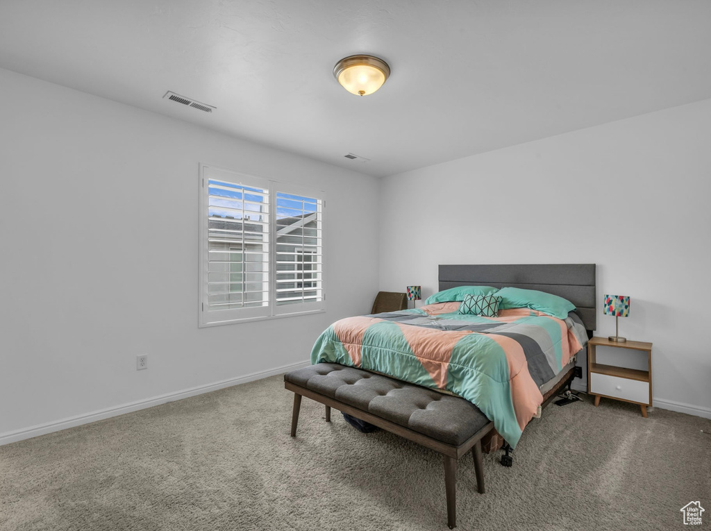 Bedroom featuring carpet floors and baseboards