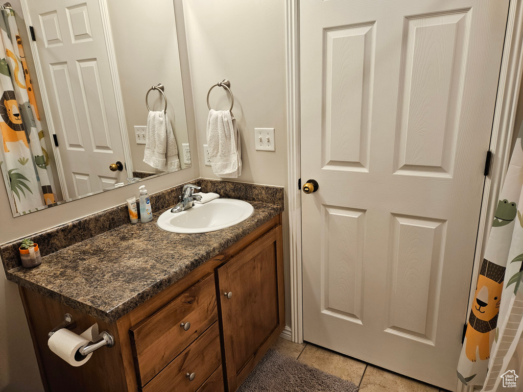 Bathroom featuring tile patterned flooring and vanity