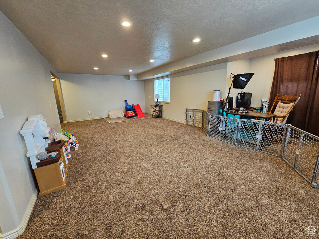Playroom featuring a textured ceiling, carpet floors, baseboards, and recessed lighting