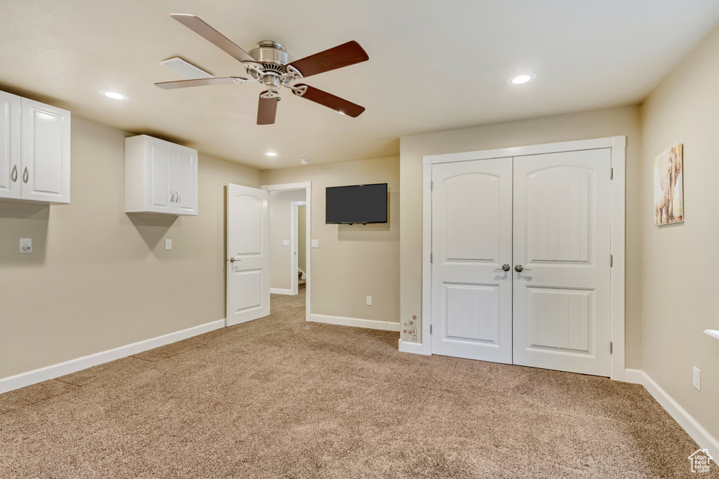 Interior space featuring baseboards, light carpet, and recessed lighting