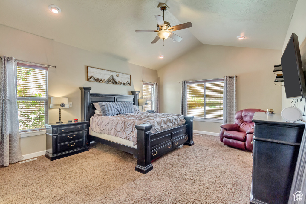 Bedroom with ceiling fan, vaulted ceiling, carpet flooring, and baseboards