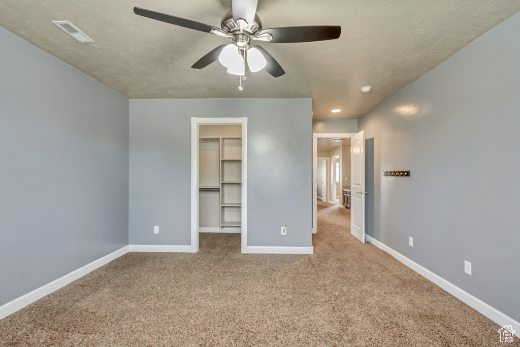 Unfurnished bedroom featuring carpet, visible vents, and baseboards