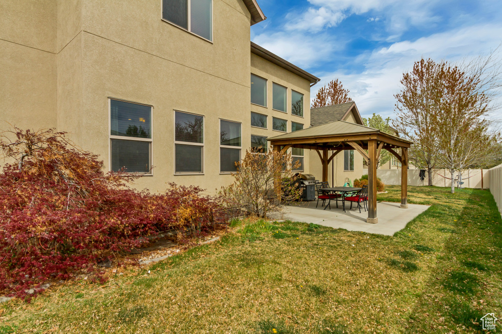 View of yard featuring a patio area, a fenced backyard, and a gazebo