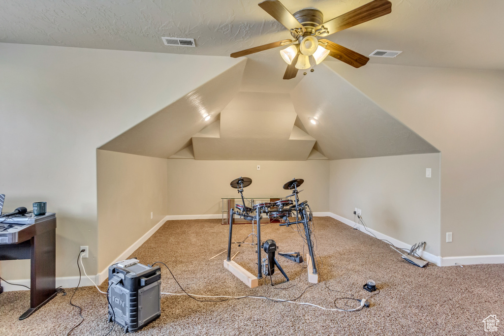 Bonus room with carpet, lofted ceiling, visible vents, a ceiling fan, and baseboards
