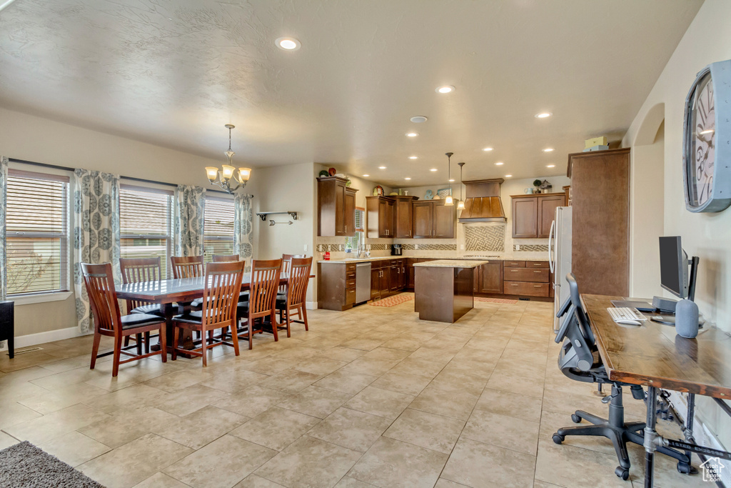 Dining area featuring recessed lighting, baseboards, and a notable chandelier