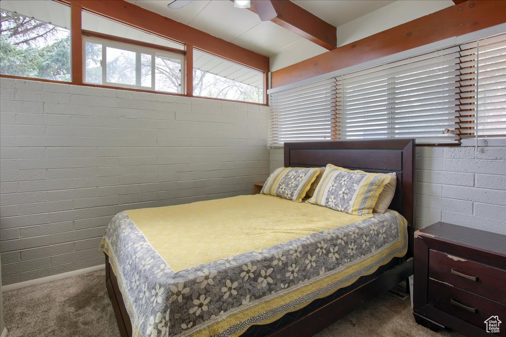 Bedroom featuring beam ceiling, carpet floors, and ceiling fan