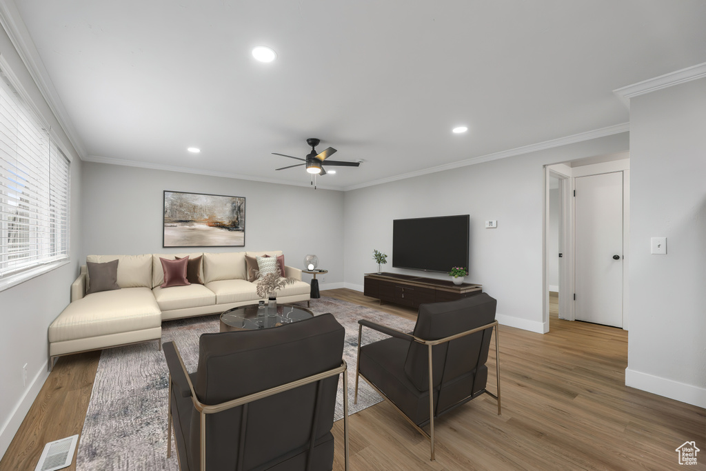 Living area featuring baseboards, recessed lighting, ceiling fan, and wood finished floors