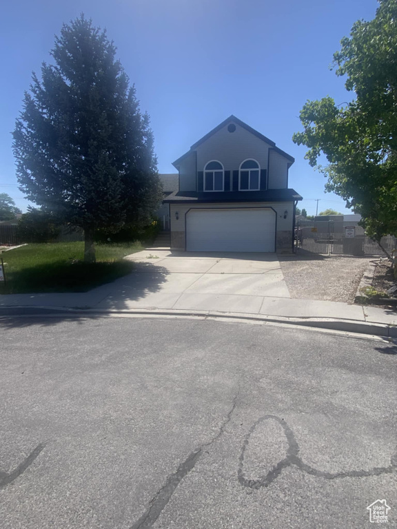 Traditional home featuring a garage and driveway