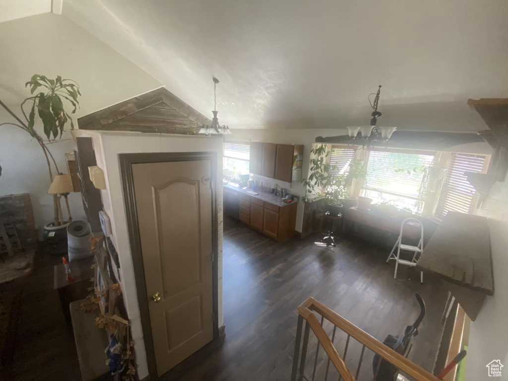Interior space featuring dark wood-style floors and a chandelier
