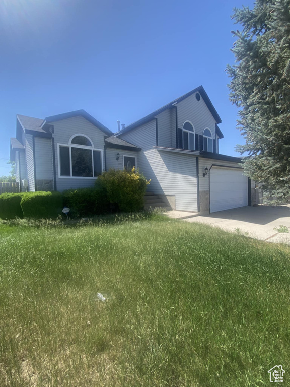 View of front of property with driveway and a garage