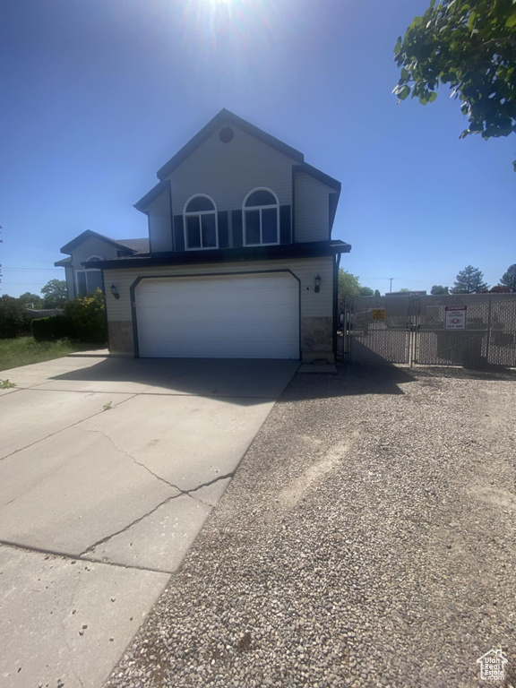 Traditional home featuring concrete driveway and a garage