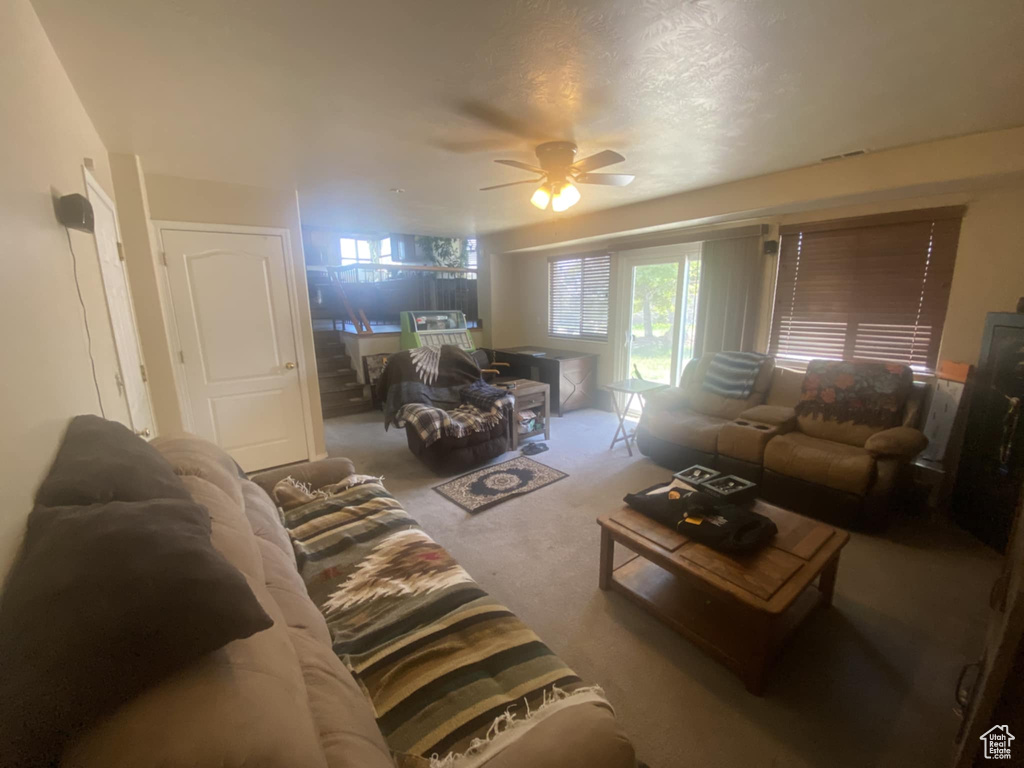 Living room featuring ceiling fan and carpet floors