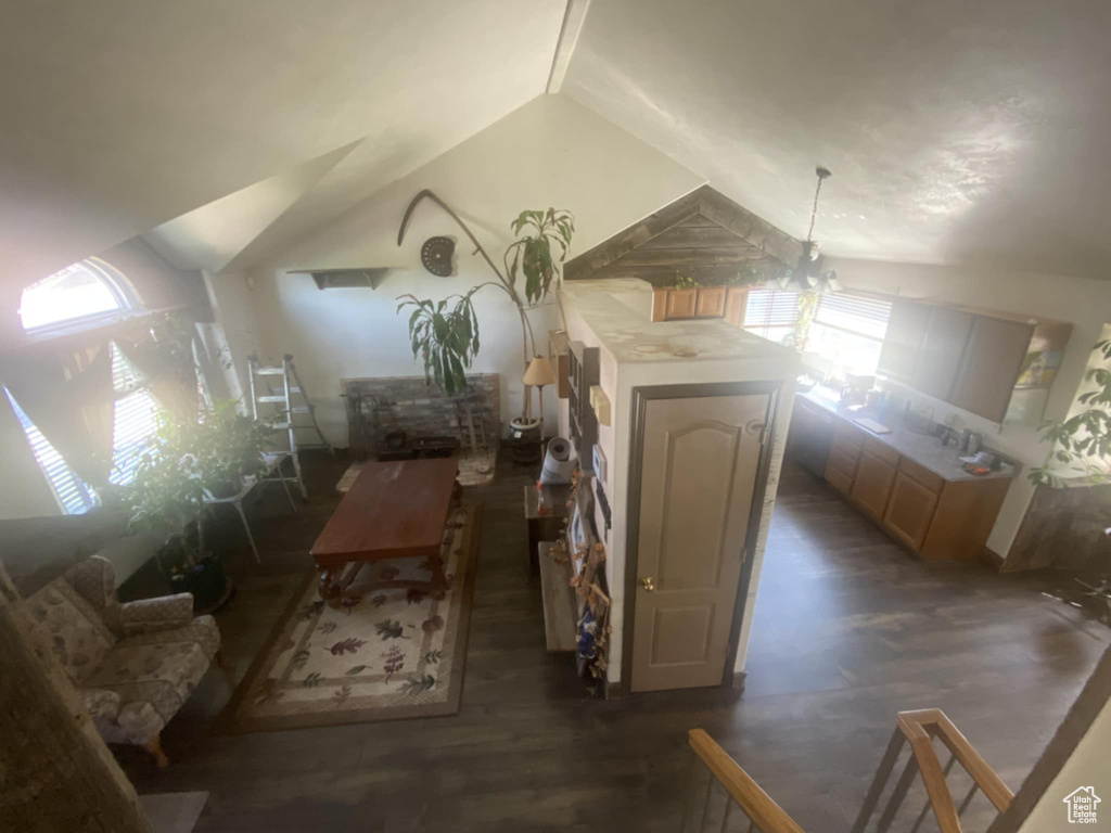Additional living space featuring lofted ceiling and wood finished floors