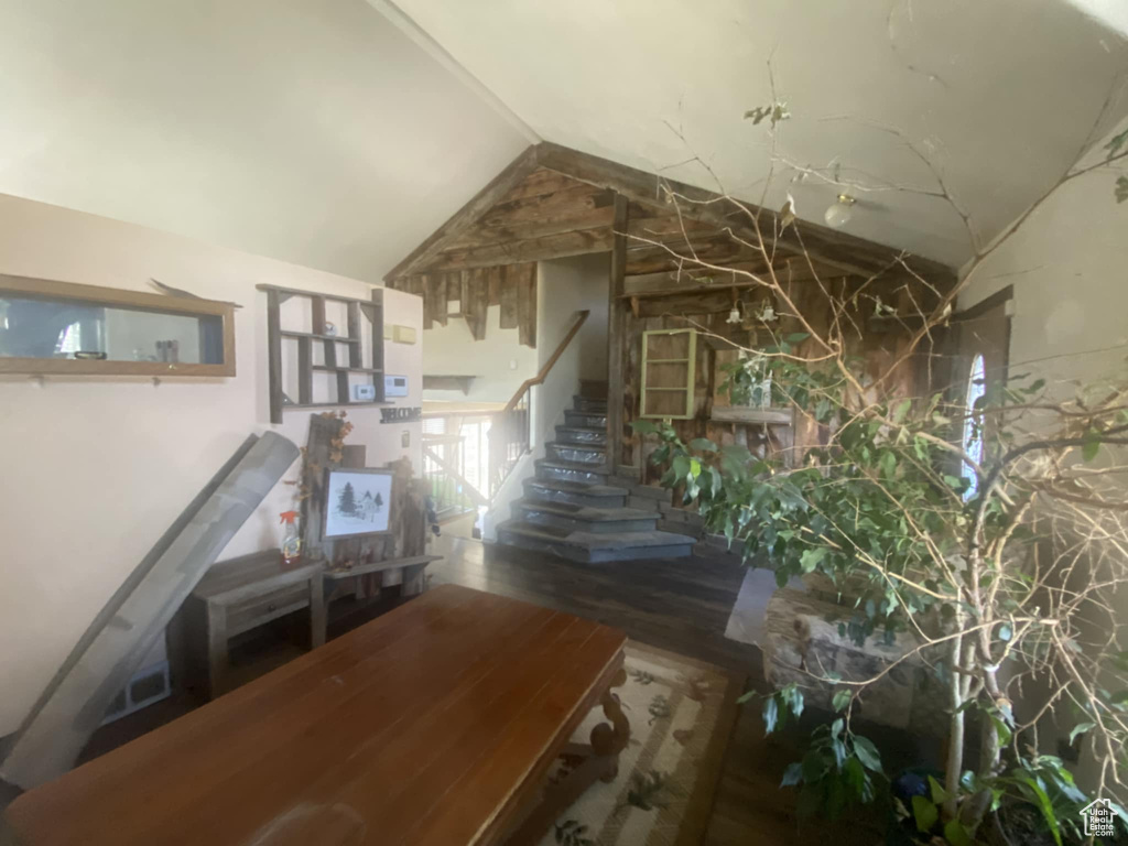 Corridor featuring stairs and vaulted ceiling