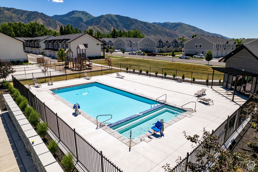 Community pool featuring a residential view and a mountain view