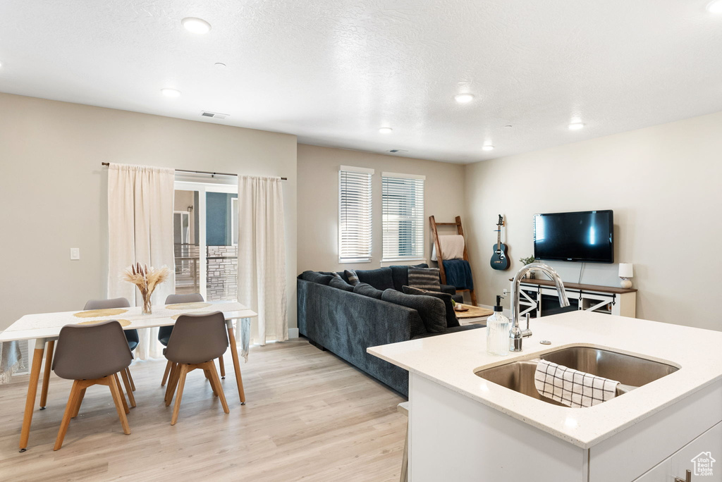 Living area featuring visible vents, recessed lighting, and light wood-style floors