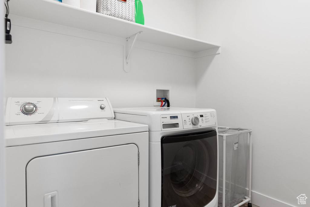 Laundry room featuring washing machine and dryer, baseboards, and laundry area