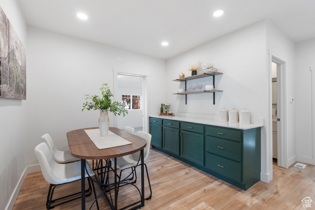 Interior space featuring recessed lighting, light wood-style flooring, green cabinets, and light countertops