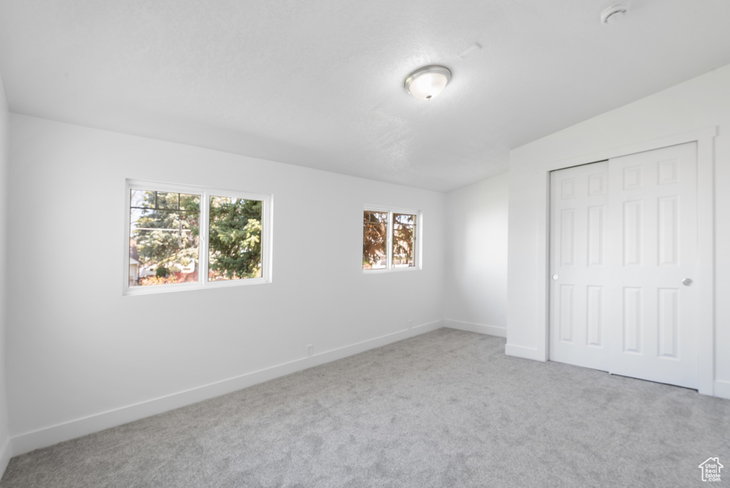 Unfurnished bedroom with baseboards, carpet flooring, and a closet