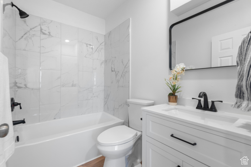 Full bath featuring toilet, vanity, and bathtub / shower combination