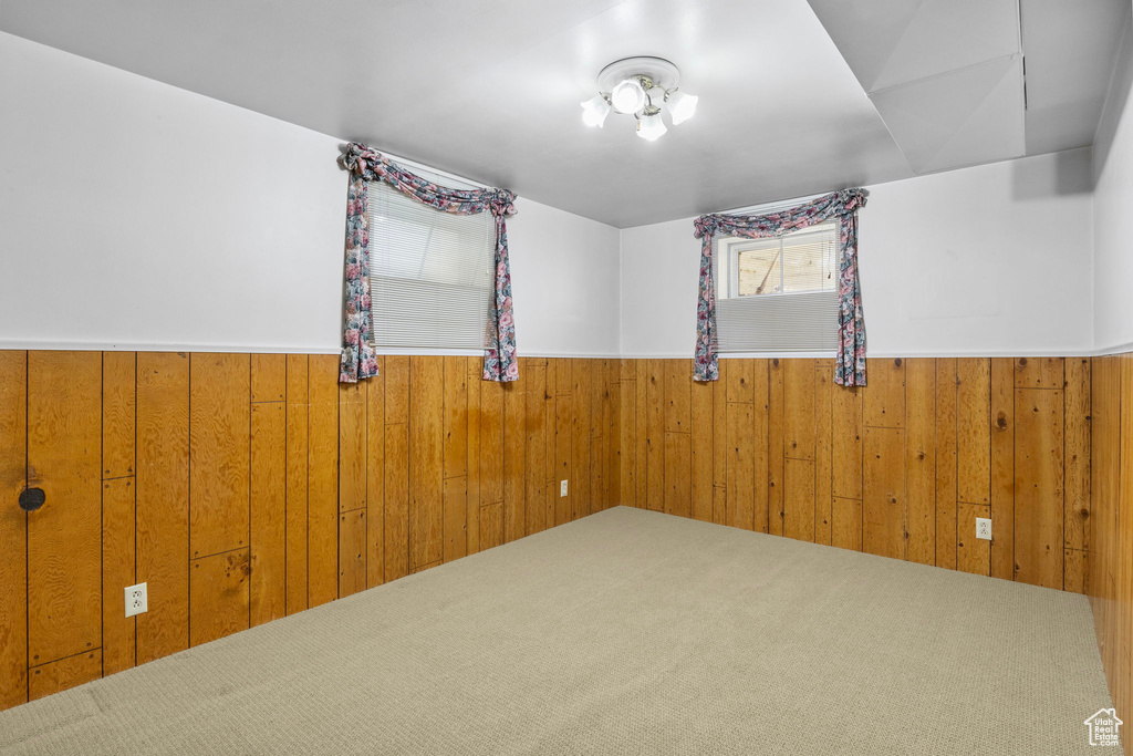 Spare room featuring a wainscoted wall and wood walls