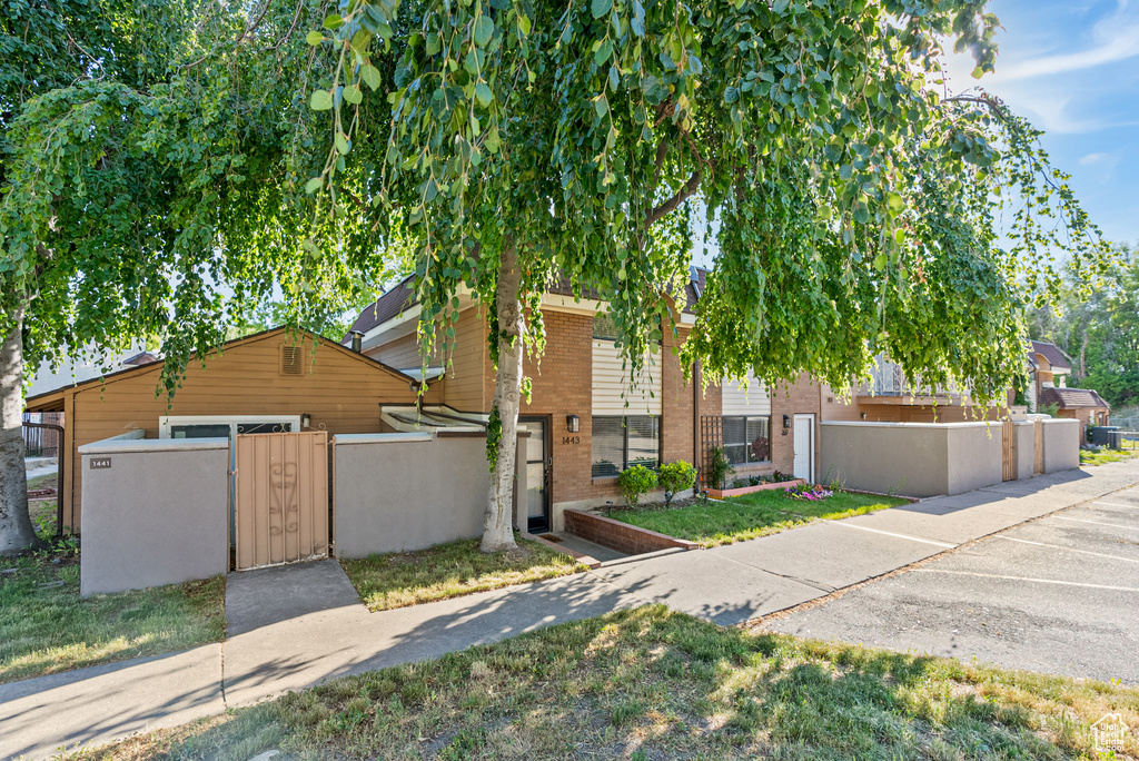 View of front of house with a fenced front yard and a gate