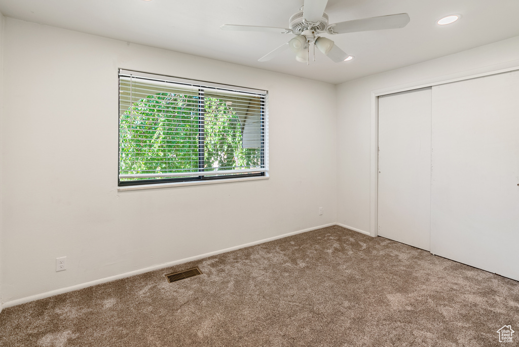 Unfurnished bedroom with carpet flooring, a closet, recessed lighting, a ceiling fan, and baseboards
