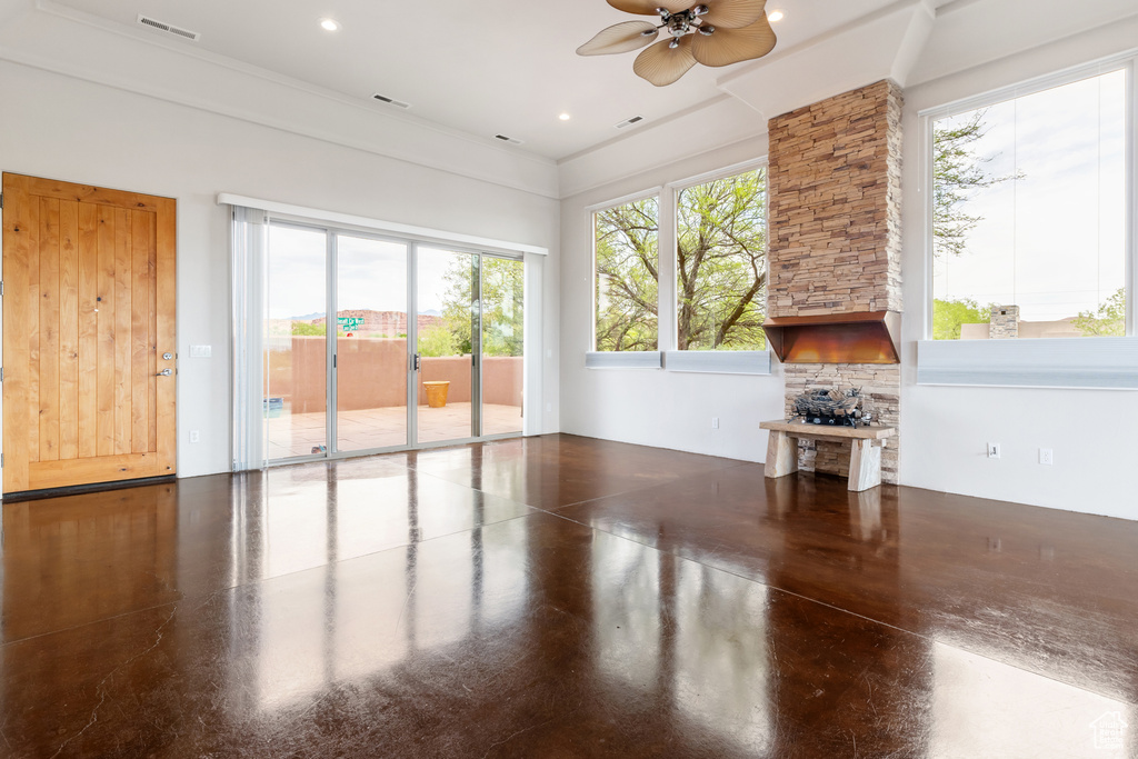Unfurnished living room featuring visible vents, a ceiling fan, and finished concrete floors